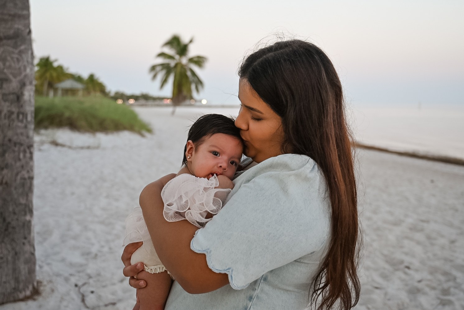Mother kissing baby